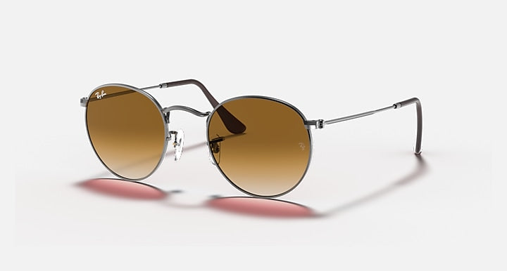 Ray-Ban RB3447N round sunglasses with silver frame and brown tinted lenses