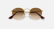 Ray-Ban round metal sunglasses with gold frame and dark brown tinted lenses