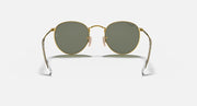 Round metal sunglasses with gold frame and dark green lenses, front view with temples visible.