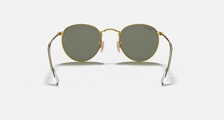 Round metal sunglasses with gold frame and dark green lenses, front view with temples visible.