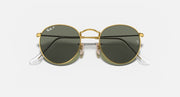 Round metal sunglasses with gold frame and dark lenses, front view showing nose bridge.