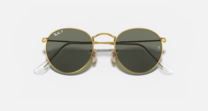 Round metal sunglasses with gold frame and dark lenses, front view showing nose bridge.