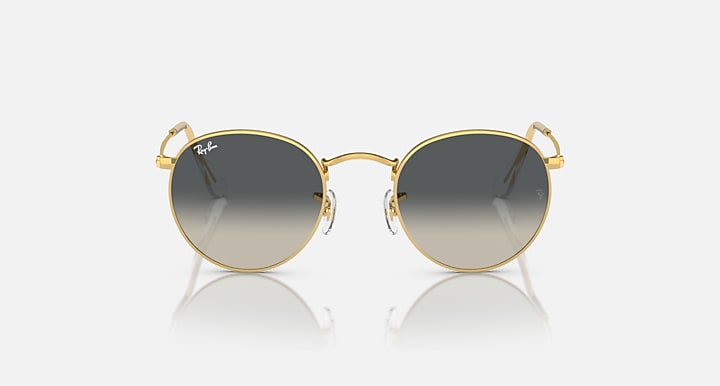 Round metal sunglasses with gold frames and dark tinted lenses, front view.