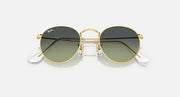 Round metal sunglasses by Ray-Ban, gold frames, dark lenses with white temple tips, angled