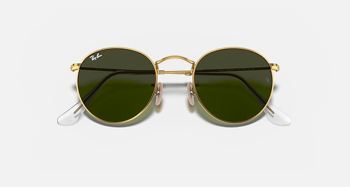 Gold metal round sunglasses with dark lenses and clear temple tips