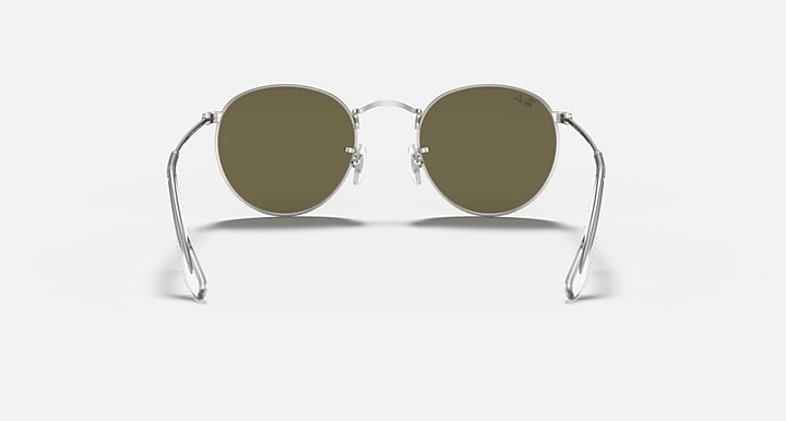 Round metal sunglasses with silver frame and olive tinted lenses