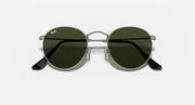 Ray-Ban round metal sunglasses with dark green lenses and black temple arms
