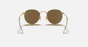 Gold metal round sunglasses with dark brown lenses and nose bridge