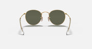Round metal sunglasses with gold frame, round dark green lenses, and hinged temples