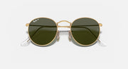 Round metal sunglasses with gold frame and glossy dark green lenses, visible hinge