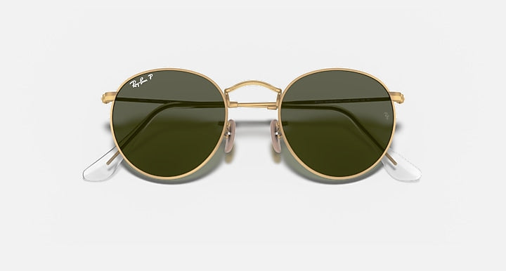 Round metal sunglasses with gold frame and glossy dark green lenses, visible hinge