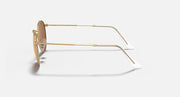 Round metal sunglasses side view with gold frame and light pink lenses