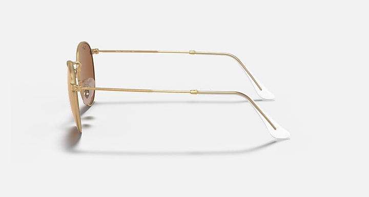 Round metal sunglasses side view with gold frame and light pink lenses