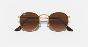 Round metal sunglasses with gold frame, dark brown lenses, black temple arms