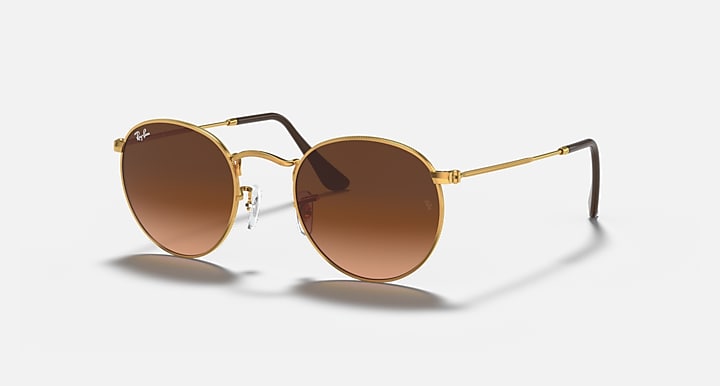 Round metal sunglasses with gold frame and brown tinted lenses, straight arms