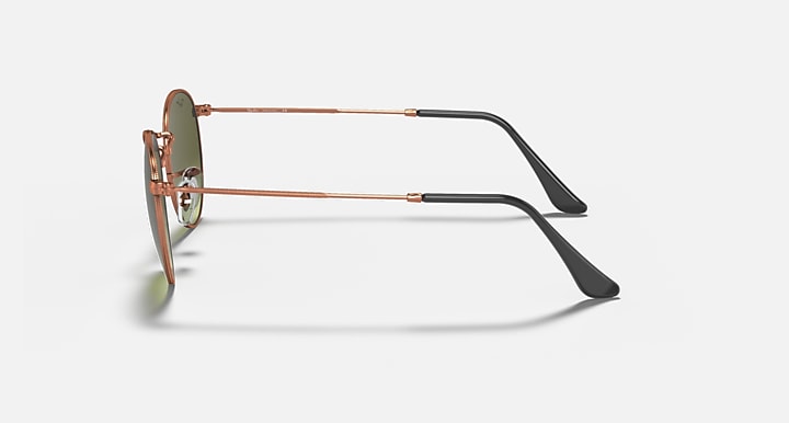 Round metal sunglasses side view with rose-gold frame and olive tinted lenses