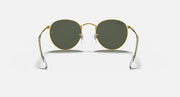 Round metal sunglasses with gold frame and dark green lenses, front view on neutral background.