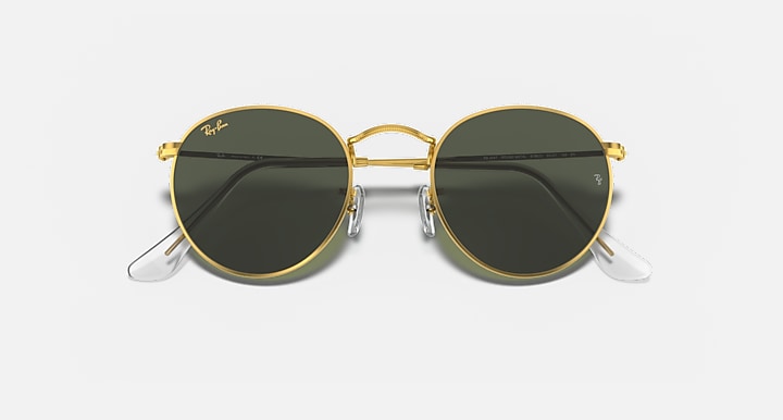 Round metal sunglasses with gold frame and dark lenses, front view with reflective tint.
