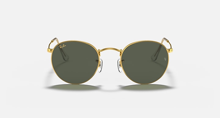 Round metal sunglasses with gold frame and dark green mirrored lenses, front view close-up.