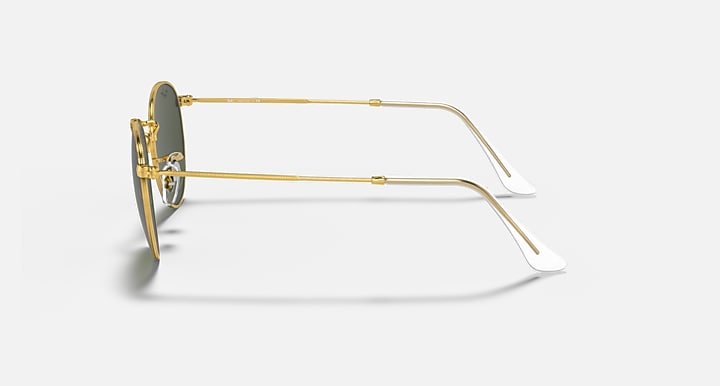 Side view of round metal sunglasses with gold frame and dark tinted lenses, clear arm details.
