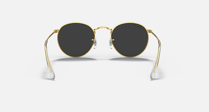 Gold round metal sunglasses with dark smoke lenses and clear temple arms, front view.