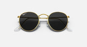 Gold round metal sunglasses with black lenses and clear temple tips, front close-up.