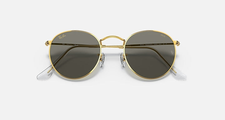 Round metal sunglasses with gold frames and dark gray mirrored lenses