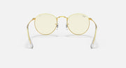 Round metal sunglasses with light gold frames and pale lenses