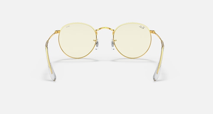 Round metal sunglasses with light gold frames and pale lenses