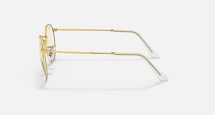 Round metal sunglasses side view with light gold frame and pale tinted lenses
