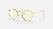 Round metal sunglasses with light gold frames and pale tinted lenses