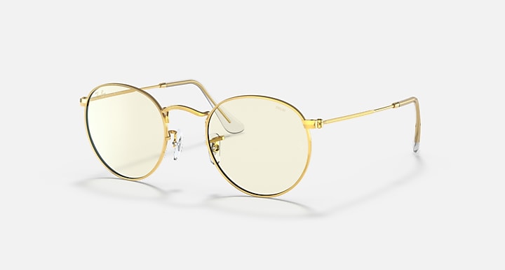 Round metal sunglasses with light gold frames and pale tinted lenses