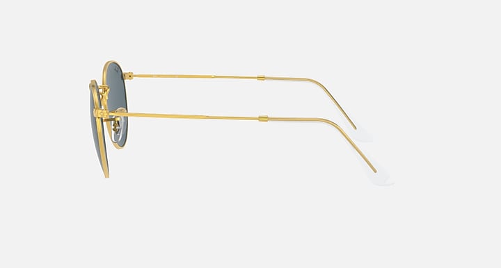 Gold round metal sunglasses in side profile with blue-tinted lenses and clear tips.