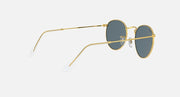 Gold round metal sunglasses with blue-tinted lenses, angled view showing temples.