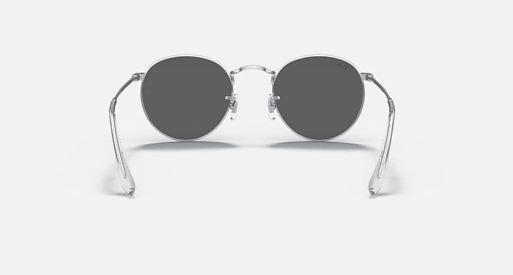 Round metal sunglasses with dark gray lenses and shiny silver frame, front view.
