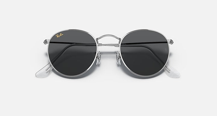 Round metal sunglasses with black lenses and shiny silver frame, front view.