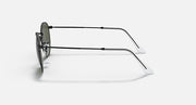 Round metal sunglasses with clear gray lenses and black frame, side view.