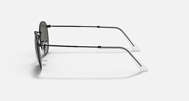 Round metal sunglasses with clear gray lenses and black frame, side view.