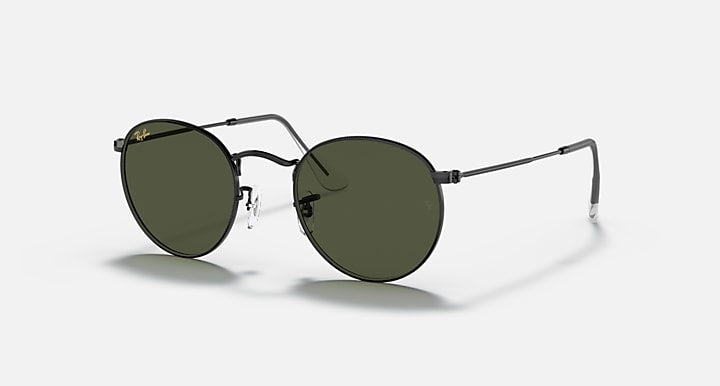 Round metal sunglasses with olive lenses and black frame, side view.