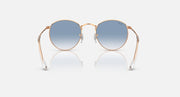 Round metal sunglasses by Ray-Ban, rose gold frames, light blue gradient lenses, front