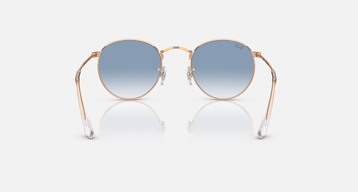 Round metal sunglasses by Ray-Ban, rose gold frames, light blue gradient lenses, front