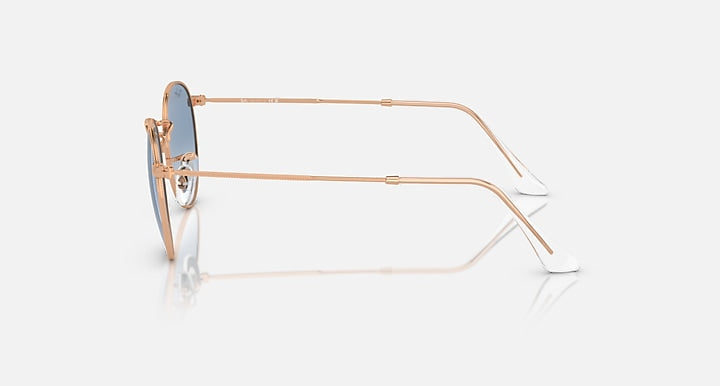 Round metal sunglasses by Ray-Ban, rose gold frames, side profile, round blue lenses