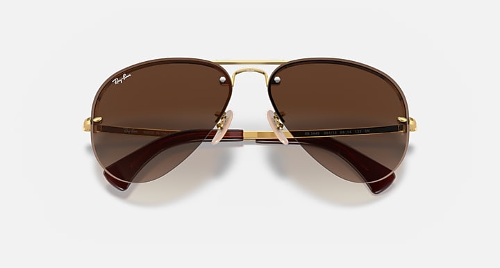 Ray-Ban aviator sunglasses with gold frame and brown lenses, top view