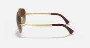 Ray-Ban aviator sunglasses with gold frame and dark brown temple tips, side view