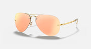 Aviator sunglasses with gold frame and peach gradient lenses, side view