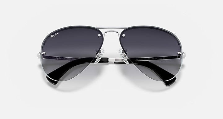 Ray-Ban aviator sunglasses with silver frame and dark lenses, top view