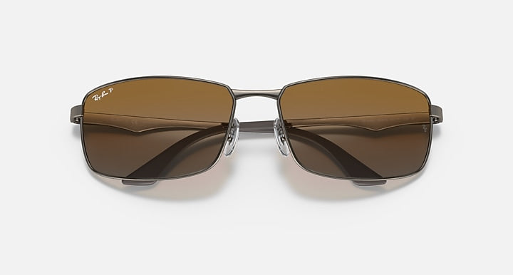 Ray-Ban RB3498 sunglasses with dark brown lenses and silver-tone metal frame, top angle