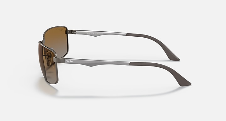 Ray-Ban RB3498 sunglasses with brown lenses and silver-tone metal frame, angled side view