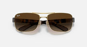 Dark brown gradient sunglasses with gold frame, front view of shield-shaped lenses.