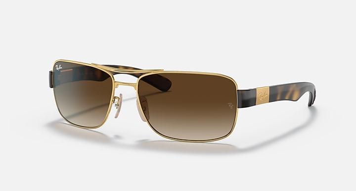 Brown gradient-lens sunglasses with gold frame and dark tortoise-pattern temple arms.